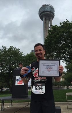 Scott Stanley celebrates victory, with Reunion Tower in the background