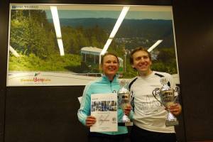 A smiling Riedl celebrates victory with the fastest woman on the day, Claudia Waidelich 